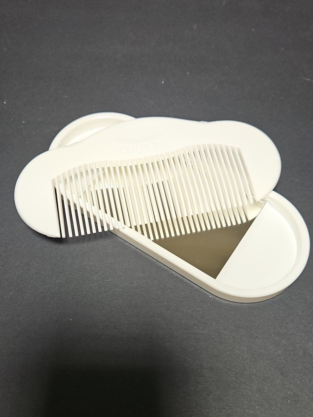 Vintage 1980s Clinique white plastic travel comb and compact mirror set